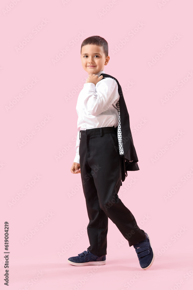 Little schoolboy on pink background