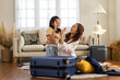 Portrait of happy love asian family mother with little girl traveler packing stuff and outfit clothes in suitcases travel bag luggage for summer holiday weekend tourist vacation trip at home.travel