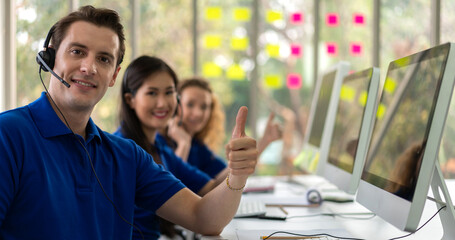 Wall Mural - Group of happy call center smiling business operator customer help support team phone services agen working and talking with headset on desktop computer at call center office