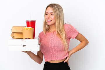 Wall Mural - Young caucasian woman holding fat food isolated on blue background suffering from backache for having made an effort