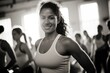 © Paleta Images - Black and white portrait of smiling women in a fitness class with light streaming in from the window, healthy lifestyle diversity concept.