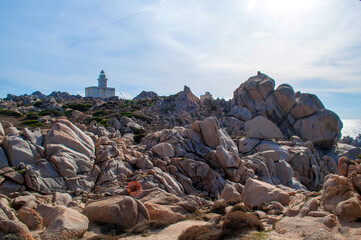 Rocky sea coast with a lighthouse in the Capo D'Orso area on the island of Sardinia, Italy