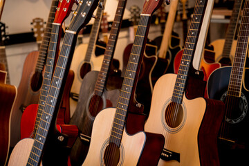 Many rows of classical guitars in the music shop