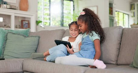 Wall Mural - Tablet, kids and sisters playing games online while sitting on a sofa in the living room of their home together. Children, technology and girl siblings streaming an online video while bonding for fun