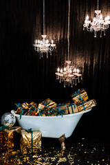 Bathtub with New Year's gifts in gold wrappers on a dark background, green modern armchair with gold armrests, chandeliers hanging from the ceiling