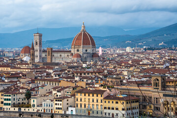 Wall Mural - panoramic view of Firenze (Florence) at sunset, taken from Piazzale Michelangelo.
historical landmarks, including the iconic Duomo and Palazzo Vechio,  can be seen at a distance