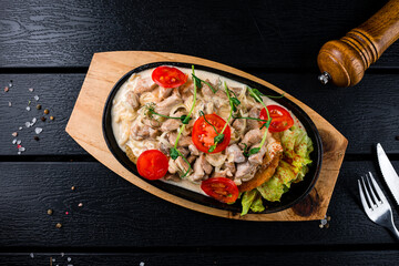 Sticker - Braised pieces of pork with onions, cream, tomatoes, lettuce, spices and herbs.