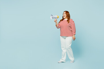 Full body young chubby overweight woman wear striped red shirt casual clothes hold in hand megaphone scream announces discounts sale Hurry up isolated on plain pastel blue background studio portrait.