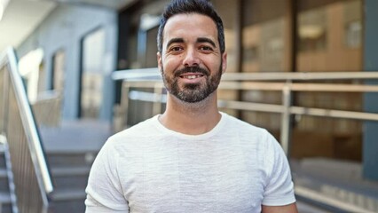 Canvas Print - Young hispanic man smiling confident standing at street