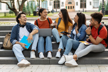 Wall Mural - Campus Life. Cheerful multiethnic college students resting outdoors between classes