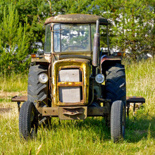 An Old Farm Tractor. View Of Headlights And Cabin