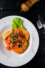 Sticker - Potato pancakes with salmon, lemon, lettuce and greens.