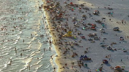 Wall Mural - Aerial view of Siesta Key beach in Sarasota, USA. Many people enjoing vacation time swimming in gulf water and relaxing on warm Florida sun at sunset