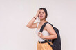 © Mdv Edwards - A stressed young Asian woman standing sideways and holding her palm to her face with backpack on one shoulder. Isolated on a white background.