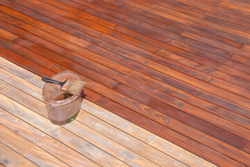 Wall Mural - Wood deck refreshing, paint brush on the bucket with oil