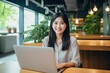 © AI Farm - Portait of Asian business woman smile with computer laptop. Generative AI