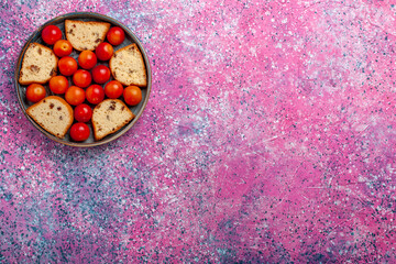 Wall Mural - top view delicious sliced cake with sour fresh plums inside pan on pink desk pie sweet sugar bake biscuit cookie fruit