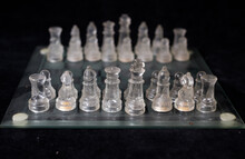 Vintage Chessboard And Chess Piece Made With Glass Isolated On Black Background 