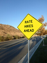 Yellow Roadside Warning Sign Warning Of Interest Rate Hikes Ahead.