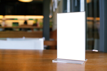 Mock up Menu frame standing on wood table in Bar restaurant cafe. space for text.