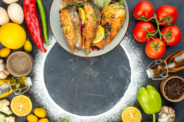 Wall Mural - top view fried fish slices with seasonings and fresh vegetables on a dark background seafood color food flour meat health meal salad