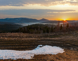 Wall Mural - early morning spring carpathian mountains plateau landscape with snow-covered ridge tops in far, ukr
