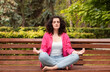 © Inna - Girl does yoga in an outdoor summer park. Performs exercises to restore strength and spirit meditates, feeling Zen-style in a public park