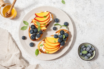 Wall Mural - Toast bread with blueberry, peach, cheese, basil leaf