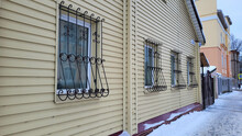 Facade With Windows And Openwork Grilles On A Winter Day.