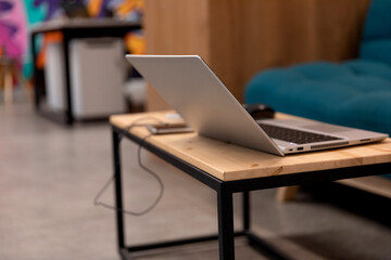 A programmer coding at lap top at coworking space