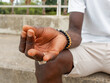 © ADDICTIVE STOCK - Crop anonymous black guy meditating in city park