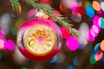 Aufkleber - Christmas tree decorated red ball toy, Fir branch with balls and festive lights on the Christmas background with sparkles and bokeh