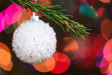 Aufkleber - Christmas tree decorated white ball toy, Fir branch with balls and festive lights on the Christmas background with sparkles and bokeh