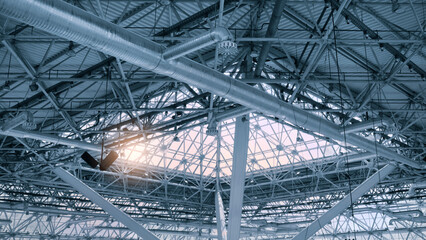 Leinwandbilder - glass ceiling through which the sun enters, metal roof beams in the interior, Ceiling fragment of metal roof of industrial building