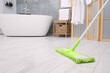 © New Africa - Cleaning dirty floor with mop in bathroom. Space for text