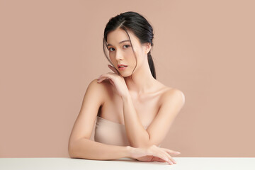 Wall Mural - Beautiful young asian woman with clean fresh skin on beige background, Face care, Facial treatment, Cosmetology, beauty and spa, Asian women portrait.