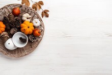 Rustic Autumnal Basket Filled With Pumpkins And Pine Cones