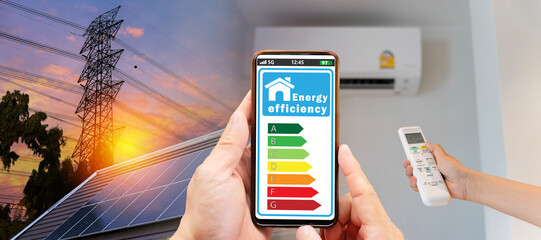 Young man turns on the air conditioner to 25 degrees to save electricity energy level chart energy saving concept.  Home appliance energy efficient.