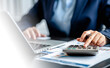 © sirichai - Close up view of Businesswomen or Accountants using calculator and a laptop computer to analyze business report graphs and finance charts at the workplace, financial and investment concept.