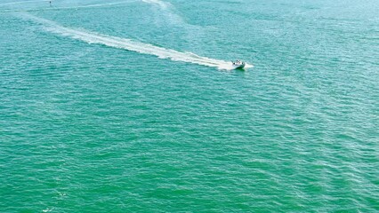 Poster - High angle view speedboat and water wake in sunny day