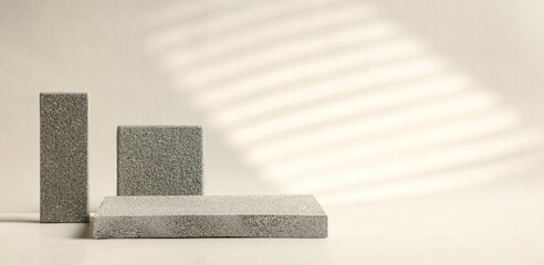 Poster - Minimal stone stage product display with sunlight from window on cream color background