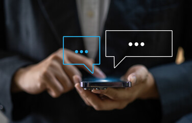 Human hand using smartphone typing Live chat chatting and social network concepts, chatting conversation working at home in chat box icons pop up. Social media marketing technology concept