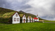 Traditional turf farm in Laufas, iceland with barn and church in summer