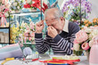 © tigercat_lpg - Asian elderly male florist owner is unwell with headaches and health deteriorating, stress from overwork in a flower shop, SME business entrepreneur.
