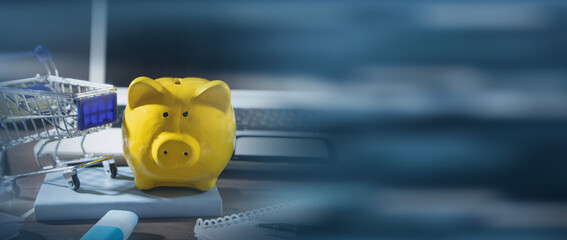 Wall Mural - Piggy bank and shopping cart on the table.