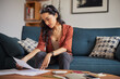 © Rido - Woman reading bills at home