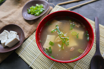 Wall Mural - miso soup or Japanese miso soup in bowl on the table. Japanese cuisine in the form of soup with dashi ingredients, tofu, seafood, vegetables, and topped with miso to taste