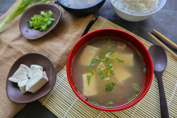 Wall Mural - miso soup or Japanese miso soup in bowl on the table. Japanese cuisine in the form of soup with dashi ingredients, tofu, seafood, vegetables, and topped with miso to taste