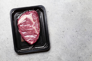 Canvas Print - Vacuum packed beef steak. Raw ribeye steak