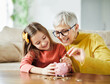 © Lumos sp - child money saving grandfmother family coin senior finance bank piggybank happy investment granddaughter girl financial elderly cash